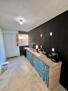 a kitchen with a counter and a counter top at Shiva Hostel in Rio das Ostras +15 photos