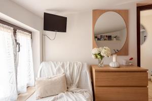 a living room with a chair and a mirror at Lovely Flat with See View in Roseto degli Abruzzi