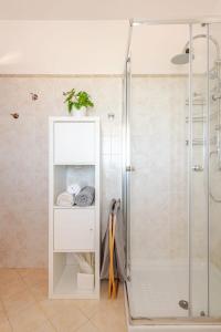 a bathroom with a shower and a cabinet with towels at Lovely Flat with See View in Roseto degli Abruzzi +17 photos