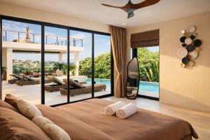 a bedroom with a bed and a view of a pool at Villa Nomada Exclusive Modern Seaview Spa and Wellness Villa with Daily Housekeeping 5 Bedrooms Sauna Ice Bath and 20 Meter Private Saltwater Pool in Ban Bang Po