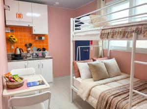 a small apartment with a bunk bed and a kitchen at 자자쿨스테이 in Seoul