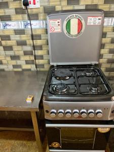 a stove top oven sitting on top of a counter at Golf BnB in Nyahururu