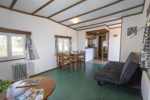 a living room with a couch and a table at Camping Domaine Papillon in Reyrevignes