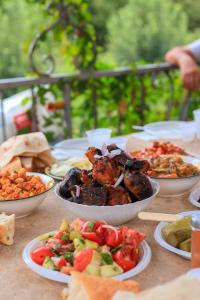 a table with bowls of food on a table at Shen toon guesthouse in Shnogh