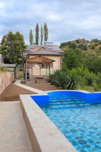 a house with a swimming pool and a gazebo at Shen toon guesthouse in Shnogh
