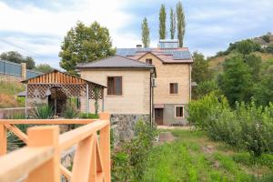 a house with solar panels on the roof at Shen toon guesthouse in Shnogh