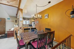 a dining room with a table and chairs at Snowy Day Chalet in Killington