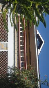 a tall building with a balcony on the side of it at Golf BnB in Nyahururu