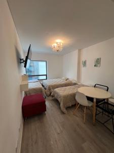 a bedroom with a bed and a table in it at Apart hotel Ciudad de Bs As in Buenos Aires