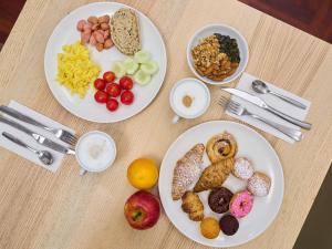 three plates of breakfast foods on a table at B&B Hotel Napoli in Naples