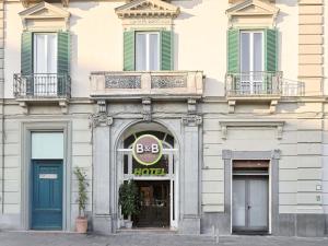 a building with a hotel sign on the front of it at B&B Hotel Napoli in Naples
