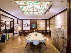 a room with a table and chairs and a stained glass ceiling at B&B Hotel Napoli in Naples +80 photos