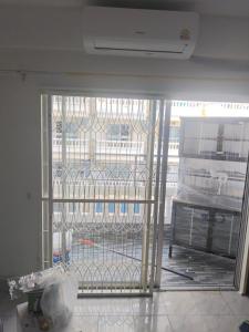an open door to a room with a cage at nirun condo 238 in Pattaya