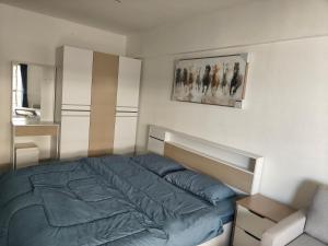 a bedroom with a bed and a picture on the wall at nirun condo 238 in Pattaya