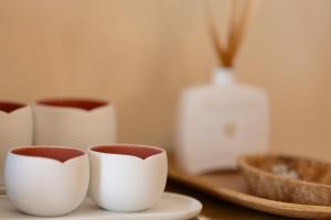 a group of white cups sitting on a table at VILLTAK La Plaza Hotel - Adults Only Recommended in Marbella
