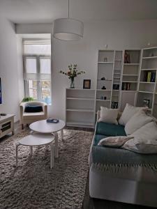 a living room with a couch and a table at Les Apparts' Hotel du Canal in Châteaulin
