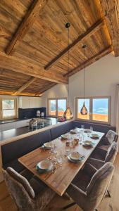 a dining room with a large wooden table and chairs at Chalet Schernthann in Salvenberg