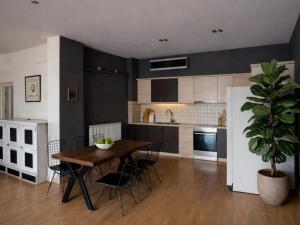 a kitchen with a wooden table and a potted plant at Filia Garden in Samos
