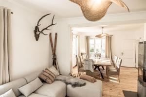 a living room with a couch and a table at Villa Stella all famous ski areas around us, 15 minutes to salzburg, mountainview in Golling an der Salzach