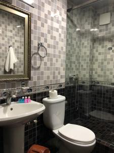a bathroom with a toilet and a sink and a shower at Nur m hotel Free transfe hotel in airoport in Yakkasaray