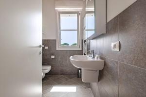 a bathroom with a sink and a toilet at Corte Fasanella 50 in Toscolano Maderno +31 photos