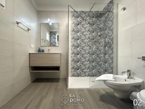 a bathroom with a shower and a toilet and a sink at Sa Domo de nonna Maria in Ottava Sassari +30 photos