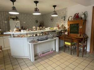 a kitchen with a counter and a table in it at Chambres d'hôtes Maison Efftermatten in Andlau +24 photos