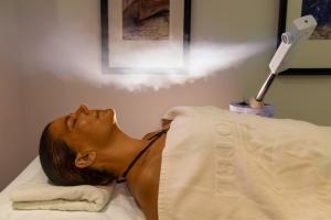 a woman laying on a bed in a hospital room at Grand Hotel Gozo in Għajnsielem