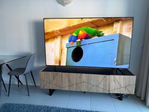 a parrot sitting on top of a tv screen at Refurbished 2 bed appt with Hot tub in Vilamoura in Vilamoura