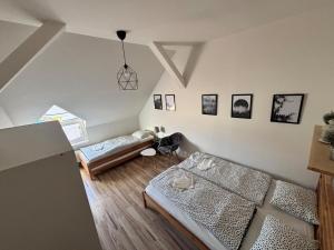 a living room with two beds and a couch at Apartmány u Klínovce in Vejprty