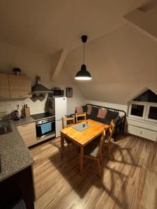 a kitchen and dining room with a table and a couch at Apartmány u Klínovce in Vejprty