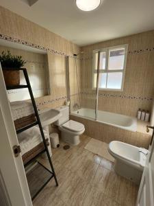 a bathroom with a sink and a toilet and a bath tub at Beach Side Heaven in Fuengirola