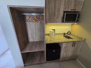 a small kitchen with a sink and a counter at La Finca hotel in Cruz del Eje