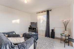 a living room with a couch and a tv at Dumbo - Île de Nantes in Nantes +6 photos