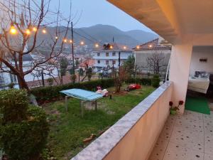 a view of a balcony with a table on the grass at Vila Ansi Klean in Udënisht