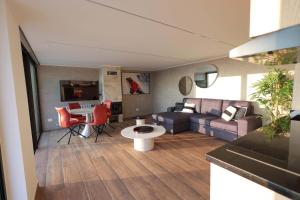 a living room with a couch and a table at Lyv Resort and Venue in Şannīn