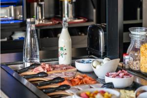 a kitchen counter with food and a bottle of milk at Brit hôtel confort Ampaline Périgueux est in Boulazac