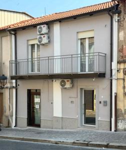 a building with a balcony on the side of it at Domus - Casa Vacanze in Cinquefrondi
