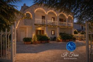 a building with christmas lights in front of it at B&B il Faso vicino Zoosafari di Fasano in Fasano