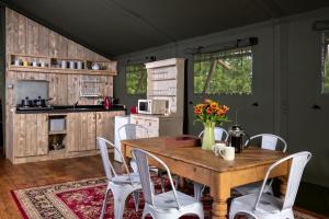 a kitchen with a wooden table and white chairs at 3 Bed in Talybont On Usk oc-wal375 in Talybont +23 photos