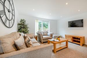 a living room with a dog sitting on a couch at 2 Bed in St. Issey oc-o27778 in Saint Issey
