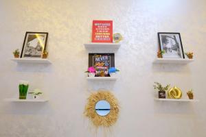 a wall with three shelves with plants and a mirror at Riad Bollywood-Golden Stay D in Benguerir