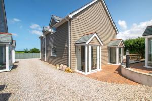 a house with a gravel driveway in front of it at 2 Bed in St. Issey oc-o27778 in Saint Issey