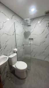 a bathroom with a toilet and a sink at Agiva Hotel in Kurinci
