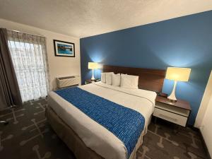 a hotel room with a large bed with a blue wall at Spokane Boutique Hotel in Spokane