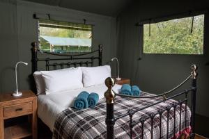 a bedroom with a bed with blue towels on it at 3 Bed in Talybont-on-Usk oc-wal376 in Talybont