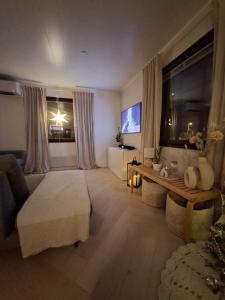 a large living room with a bed and a table at Villa Juhala in Rovaniemi