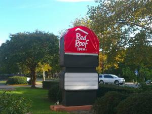 a sign for a red rock times sign at Red Roof Inn Hampton Coliseum in Hampton