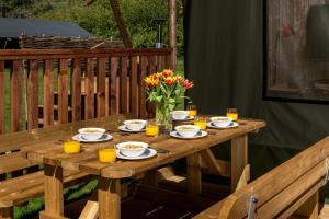 a wooden table with plates of food and orange juice at 3 Bed in Talybont-on-Usk oc-wal374 in Talybont +17 photos