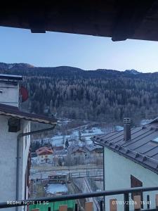 a view of a town with snow and trees at La casa del Gianni in Piano +7 photos